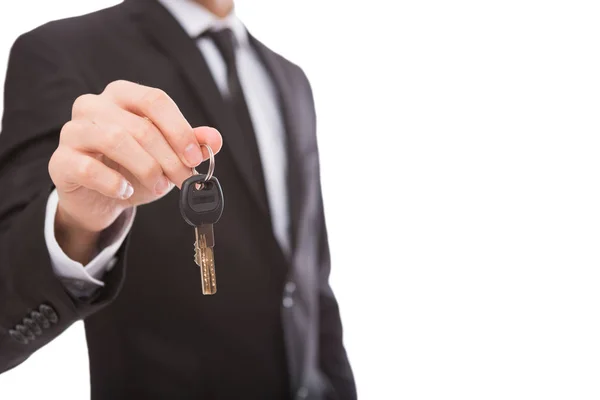 Unrecognizable man offering key to your dream — Stock Photo, Image