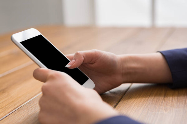 Female using smartphone, close up, side view,