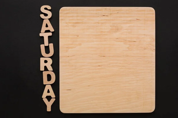 Wortsamstag mit leerer Holztafel — Stockfoto
