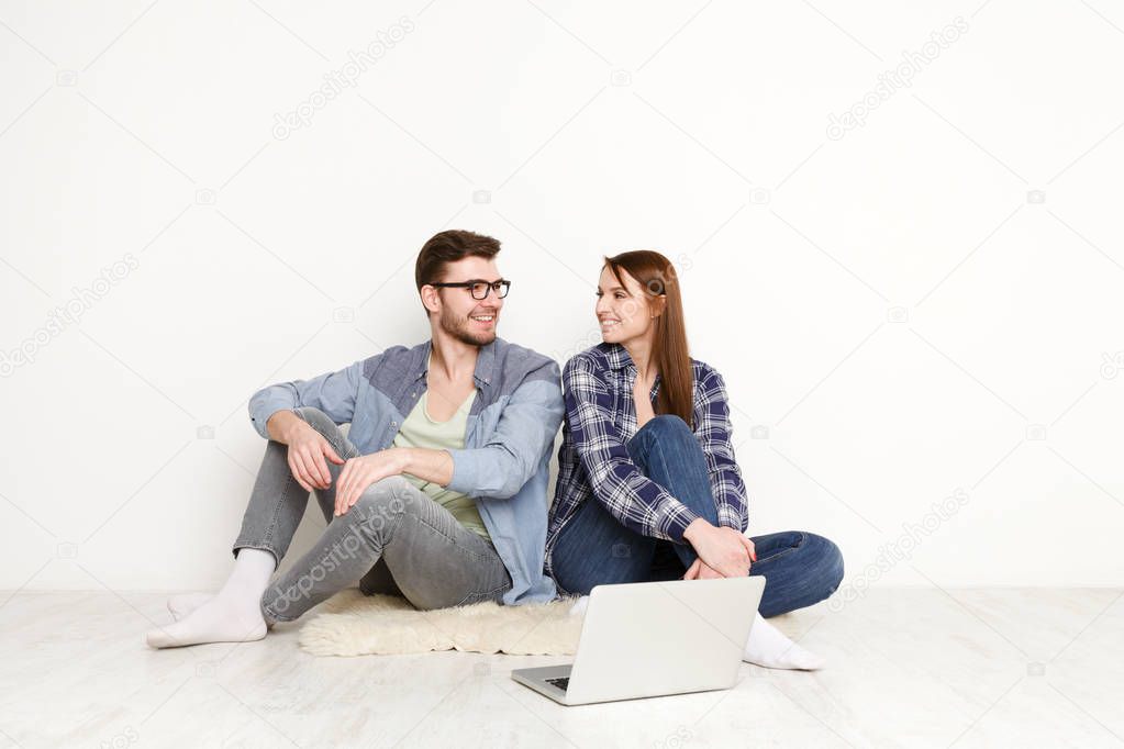 Couple discussing work in home interior