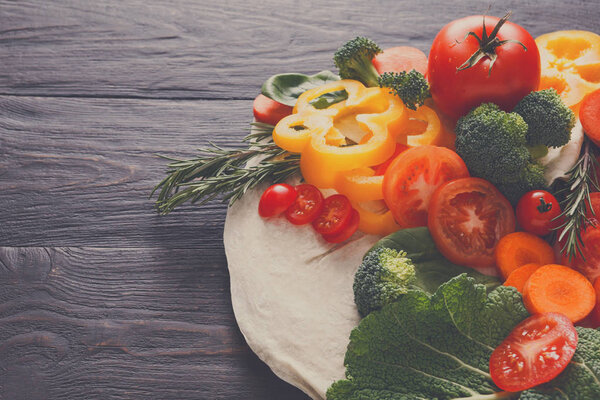 Fresh vegetables on pita bread background with copy space