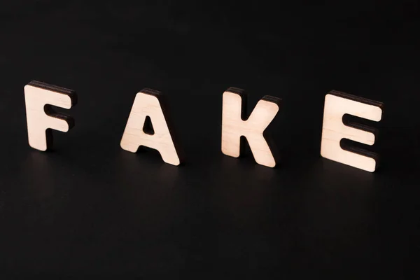 Word Fake on black background — Stock Photo, Image