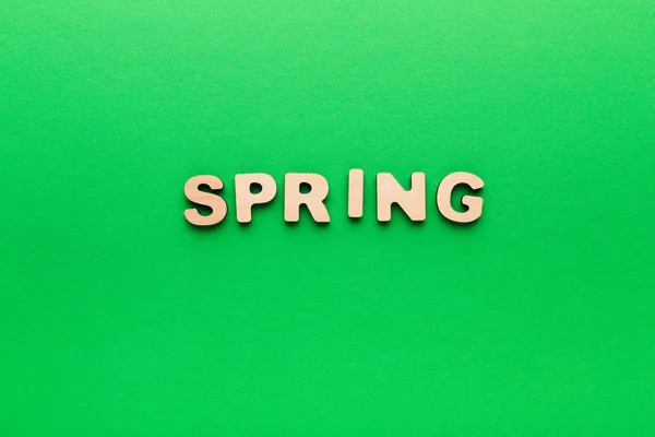 Word Spring on green background — Stock Photo, Image
