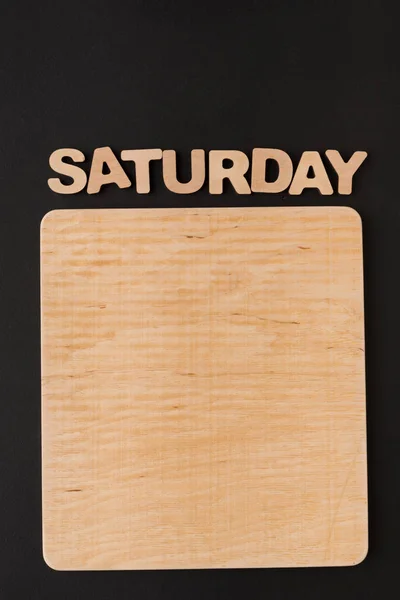 Wortsamstag mit leerer Holztafel — Stockfoto