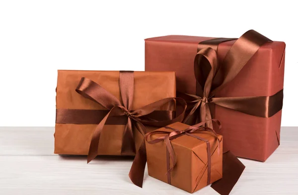 Christmas holiday gift boxes wrapped in paper on white wood — Stock Photo, Image