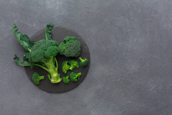 Rustic slate stone plate with broccoli , copy space