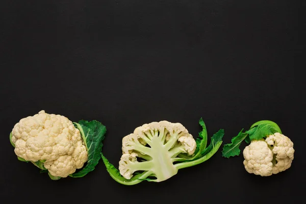 Stages of cutting cauliflower on black background — Stock Photo, Image