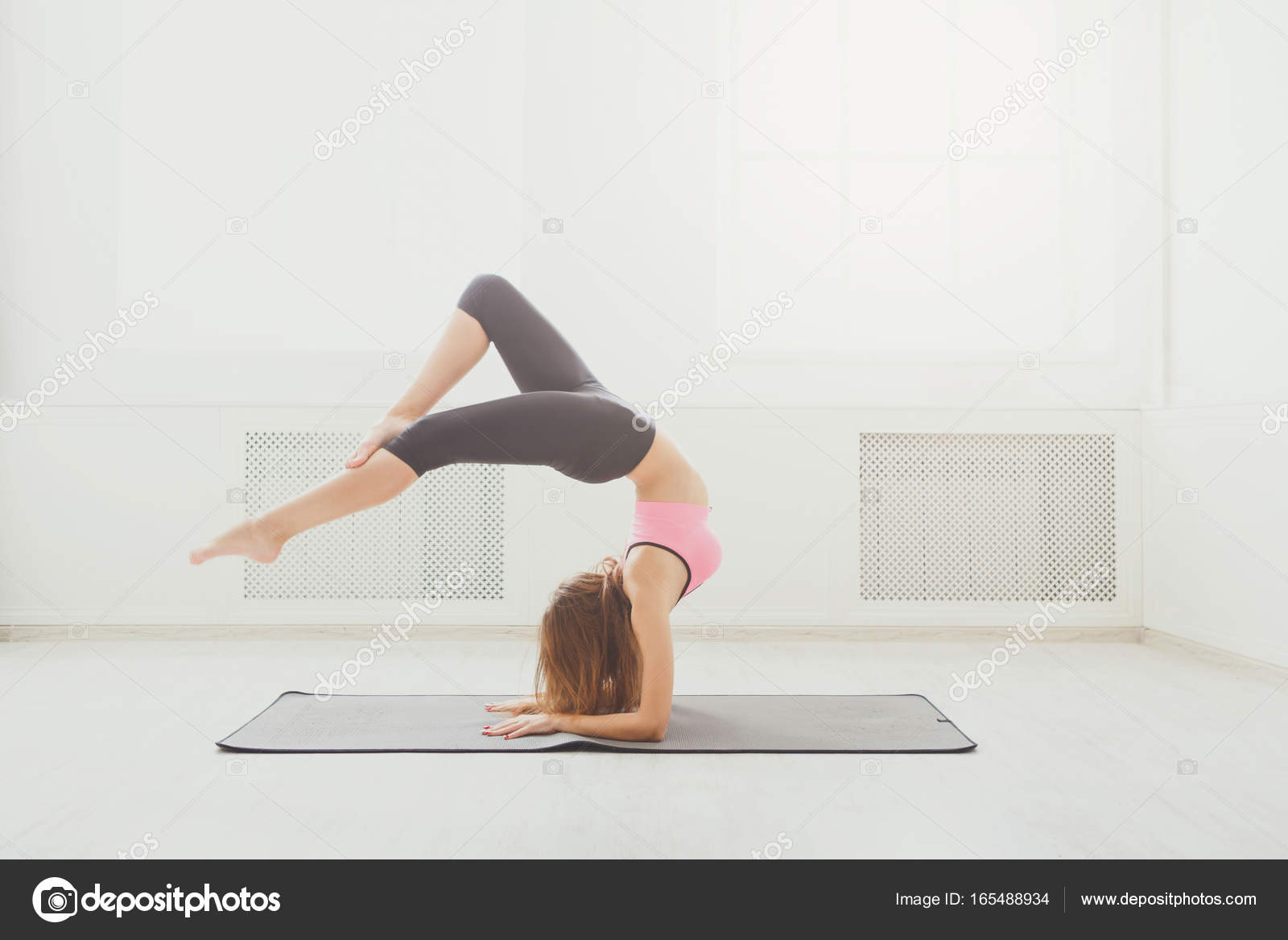 Kvinna praktisera yoga, stående i Huvudstående utgör — stockfoto © Milkos  #165488934, image size:1600x1167