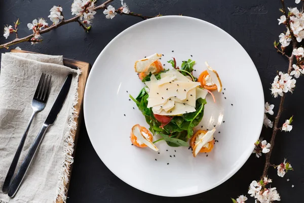 Restaurant dish on white plate on black background