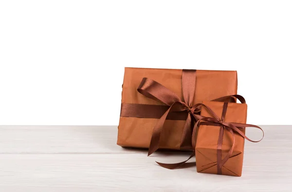 Christmas holiday gift boxes wrapped in paper on white wood — Stock Photo, Image