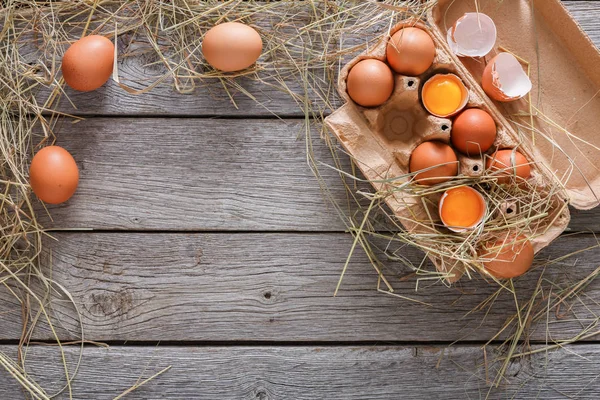 Brązowy jaja świeże w pudełku na rustykalne drewniane tła — Zdjęcie stockowe