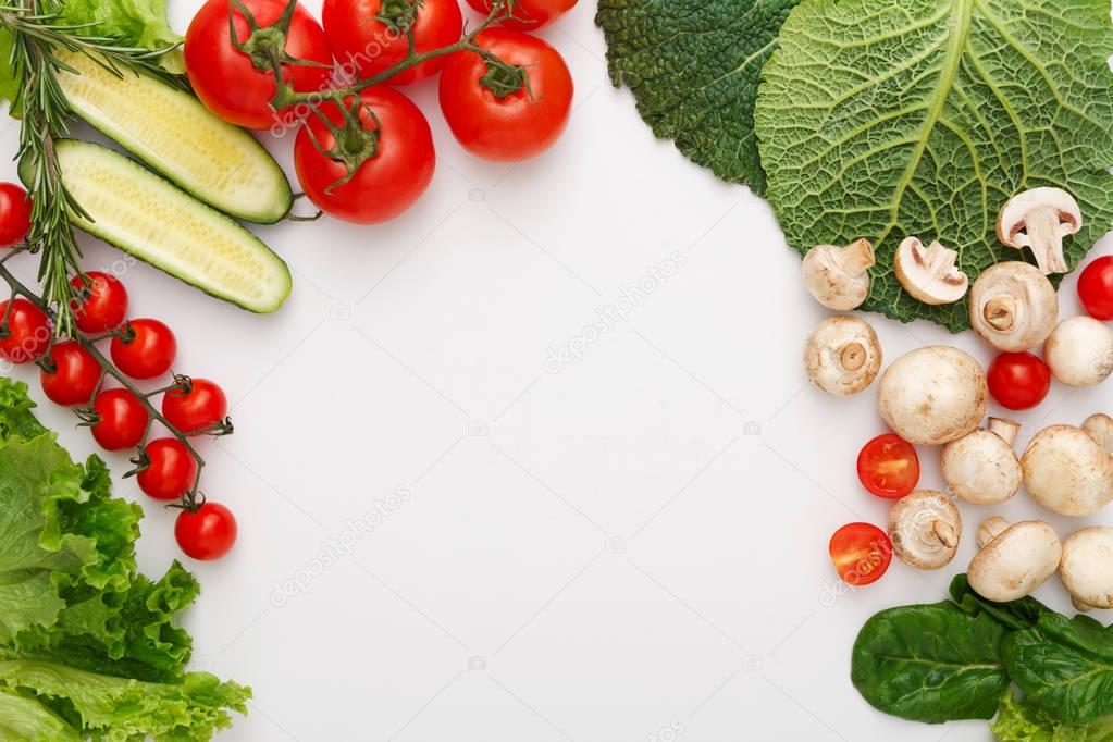 Border of fresh vegetables on white background with copy space