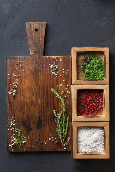 Ahşap masa ve koyu arka plan üzerinde çeşitli baharatlar
