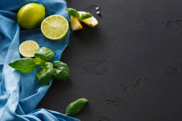 Lime and lemon with mint on black background — Stock Photo, Image