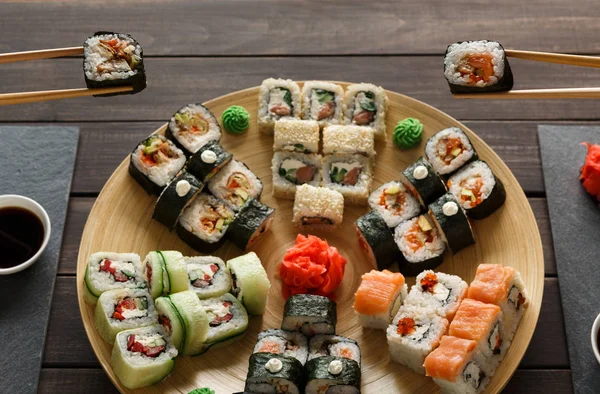 Eating set of sushi maki and rolls in japanese resaturant