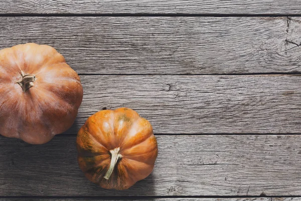Pumpkins on gray wood background with copy space