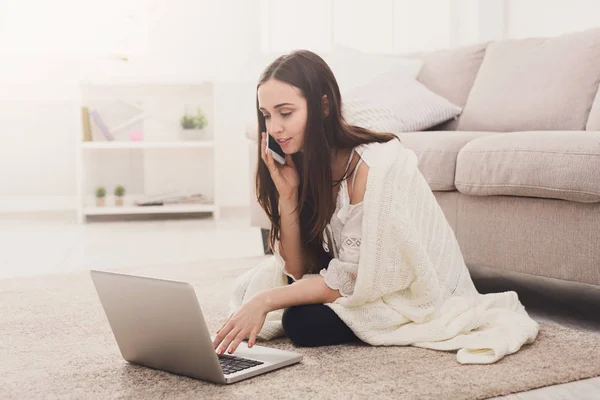 Kız bir battaniye ile bir dizüstü bilgisayar ve cep — Stok fotoğraf