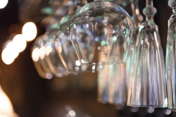 Glasses hanging on bar rack close up — Stock Photo, Image