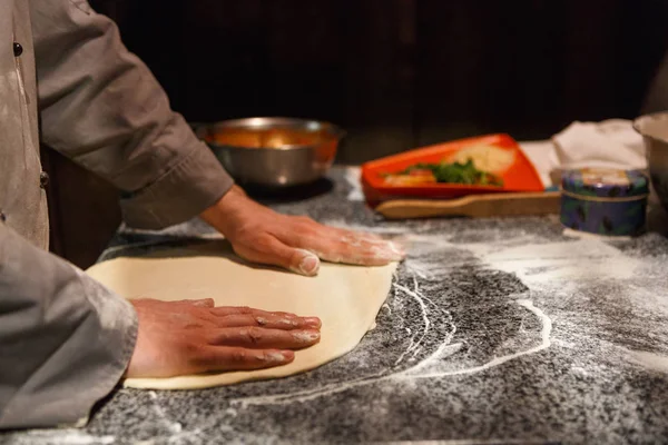 Hands kneading dough for pizza making — Stock Photo, Image