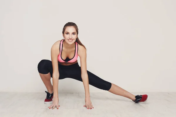Fitness woman warmup stretching training indoors — Stock Photo, Image