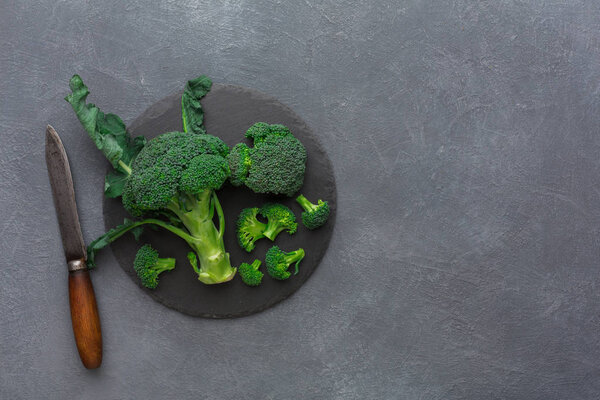 Rustic slate stone plate with broccoli , copy space