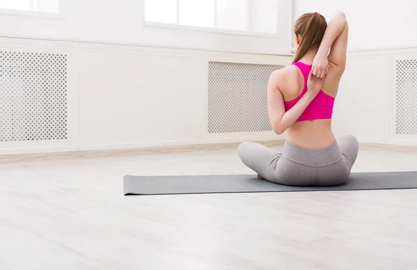 Woman training yoga in cow head pose. — Stock Photo, Image