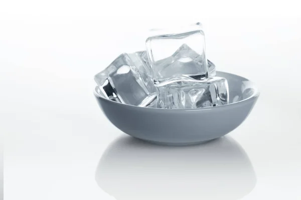 Bowl with ice cubes on white background — Stock Photo, Image