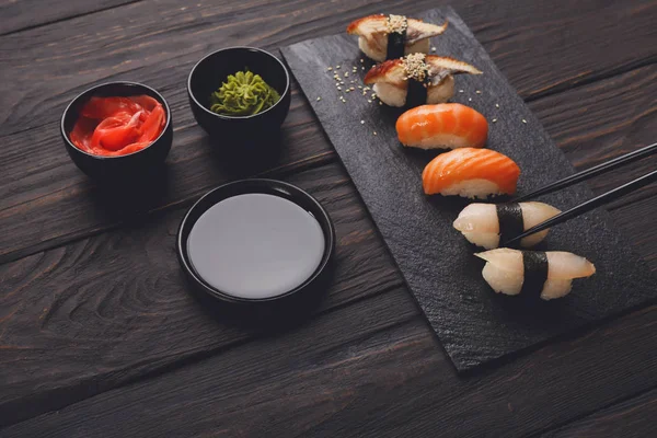 Set of sushi on black wood background, closeup — Stock Photo, Image