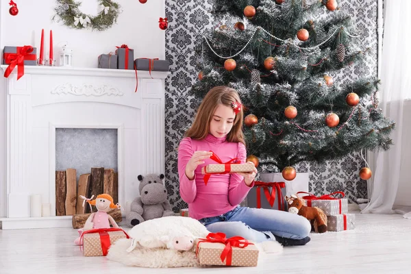 Bella ragazza scartando regali di Natale — Foto Stock