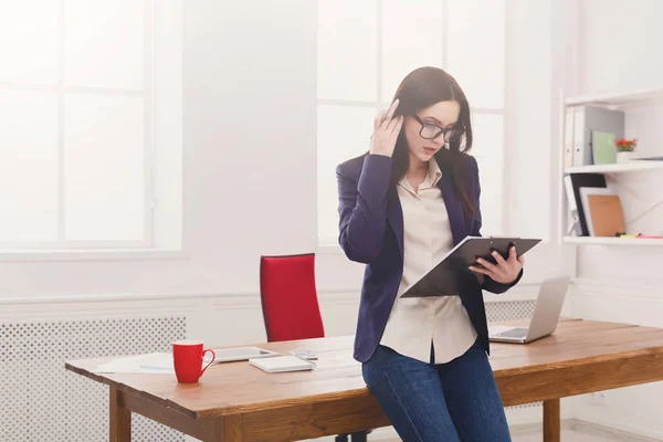 Geschäftsfrau schreibt im Büro Notizen auf — Stockfoto