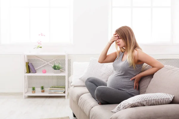 Young expectant blonde with headache — Stock Photo, Image