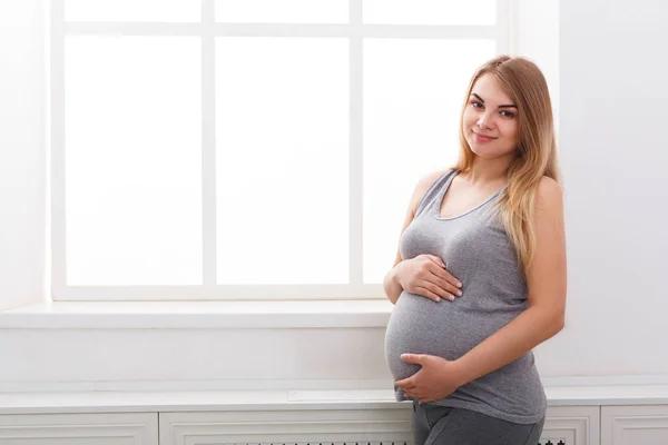Усміхнена вагітна жінка мріє про дитину, копіювати простір . — стокове фото