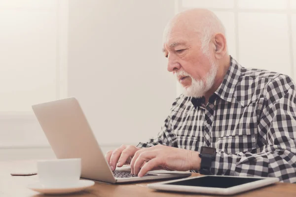 ノート パソコン コピー スペースで入力する年配の男性 — ストック写真