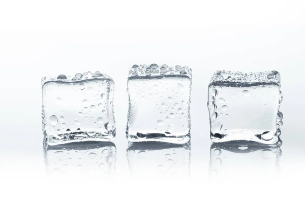 Transparent ice cubes with water drops isolated on white background — Stock Photo, Image