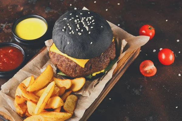 Black bun burger with potato wedges top view