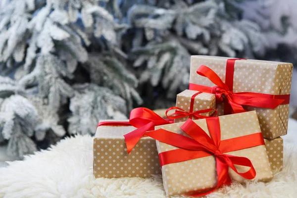 Karácsonyi ajándékok, homályos fenyő fa háttér, ünnep fogalma — Stock Fotó