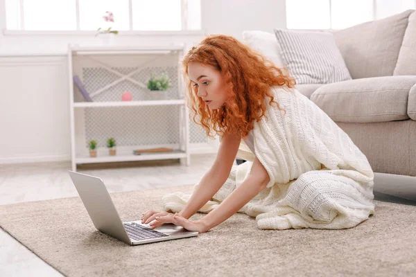 Casa accogliente. Ragazza in una coperta con un computer portatile — Foto Stock