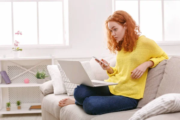 Young girl with a laptop messaging on mobile — Stock Photo, Image