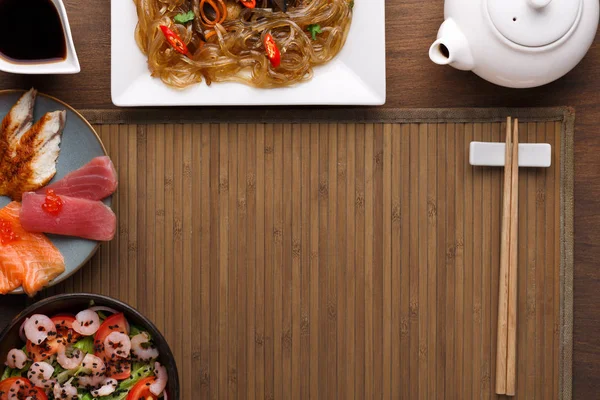 Served table with asian food in a bowl at rustic wooden background — Stock Photo, Image