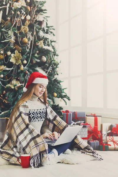 Young woman online on laptop at christmas interior — Stock Photo, Image