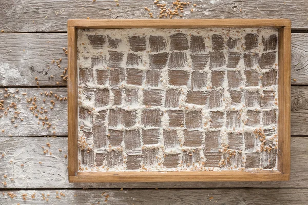 Bakery background. Flour in tray, checkered pattern