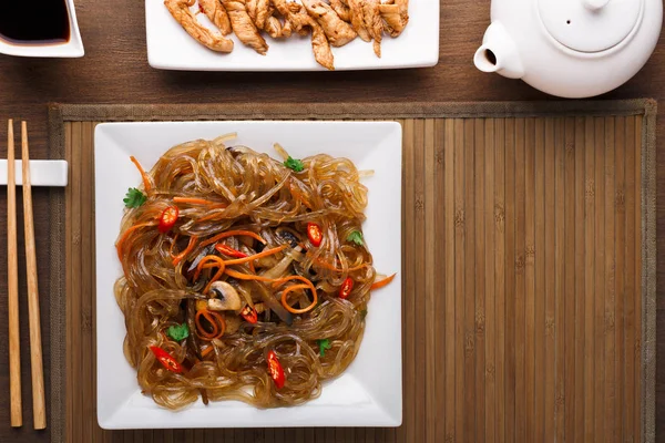 Table servie avec de la nourriture asiatique dans un bol à fond en bois rustique — Photo