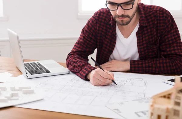 Architect working on blueprint in office — Stock Photo, Image