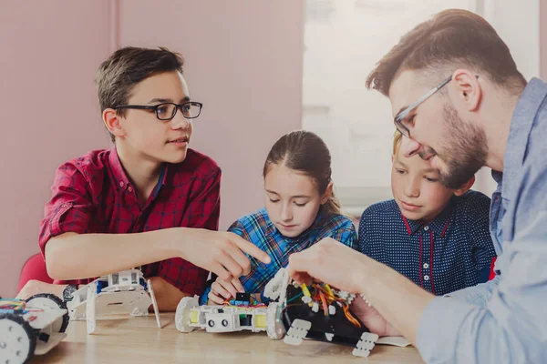 Enseignement de la tige. Enfants créant des robots avec professeur — Photo