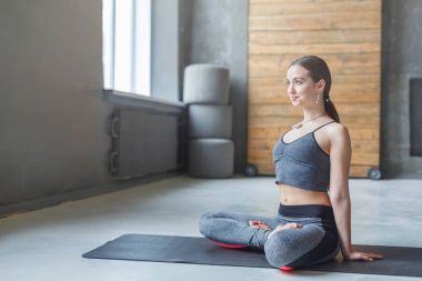 Pratik yoga padmasana içinde oturan genç çekici kadın