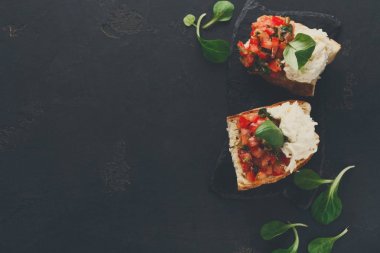 Bruschetta peynir ve siyah arka plan üzerine sebze ile