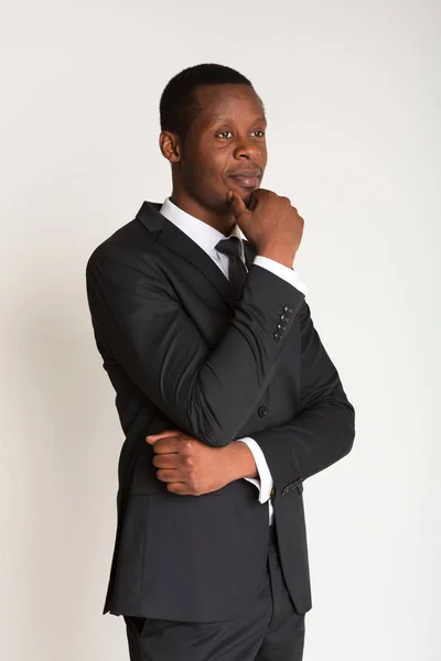 Fundersam svart man affärsman står i kostym — Stockfoto