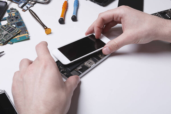 Repairman disassembling phone for inspecting