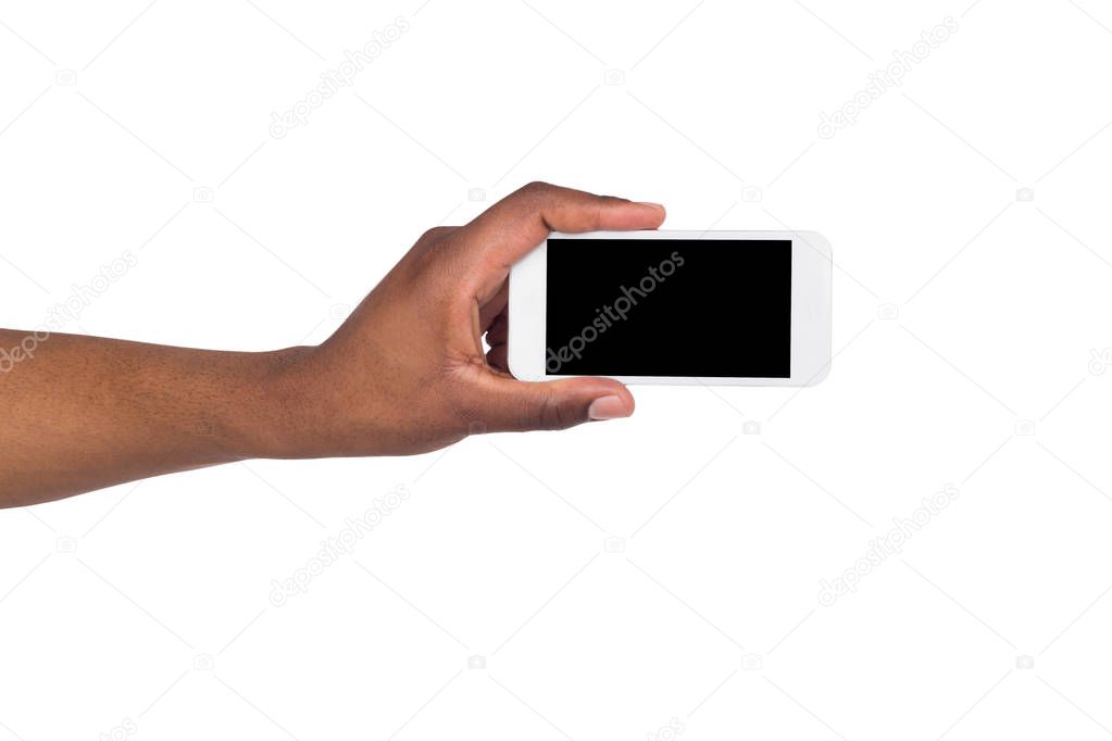 Black hand holding smartphone on isolated white background