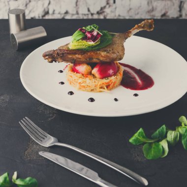 Restoran yemekleri. Ördek confit siyah adam sebze ile